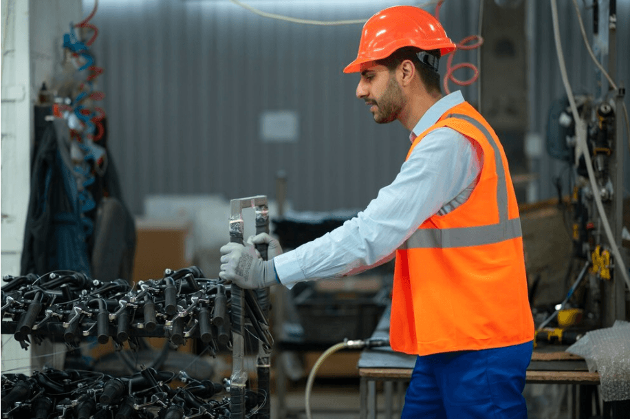 Workers performing maintenance on heavy-duty pumps in the workshop.