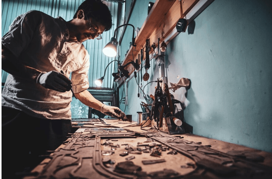 Artisans at work creating intricate handwoven textiles and traditional handicrafts supported by NEHHDC.