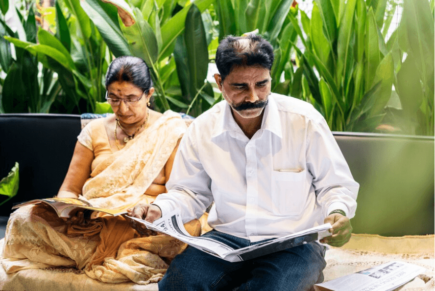 A New India Assurance representative explaining specialized insurance products to rural clients, showcasing the company’s focus on inclusivity and social welfare