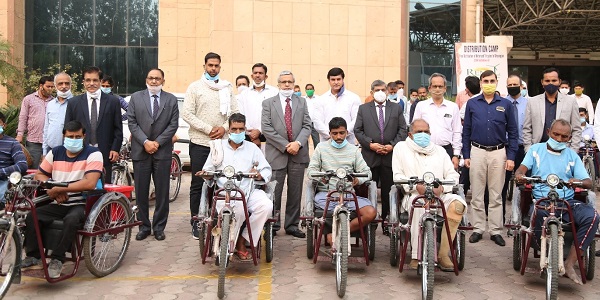 REMCL distributes motorised tricycles among divyangs