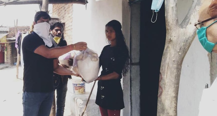 CMPDI Employees distributes grocery bags of food items at door steps